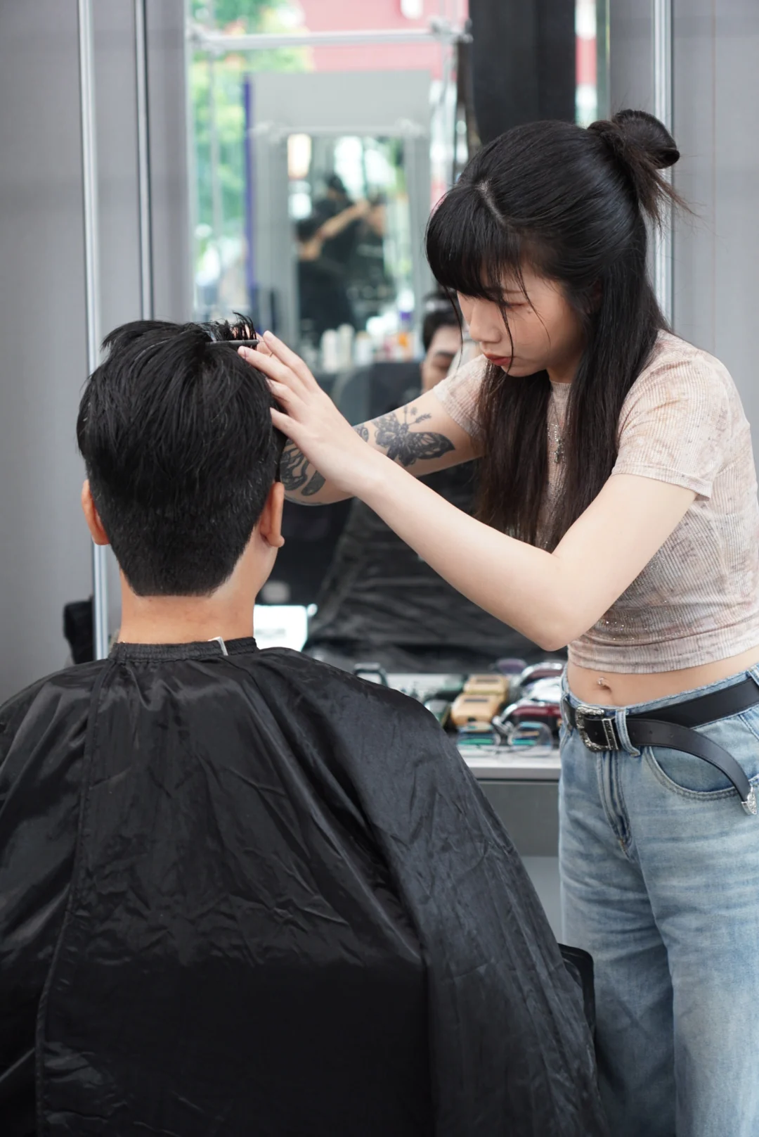 A view from behind the chair of work on the front section of hair