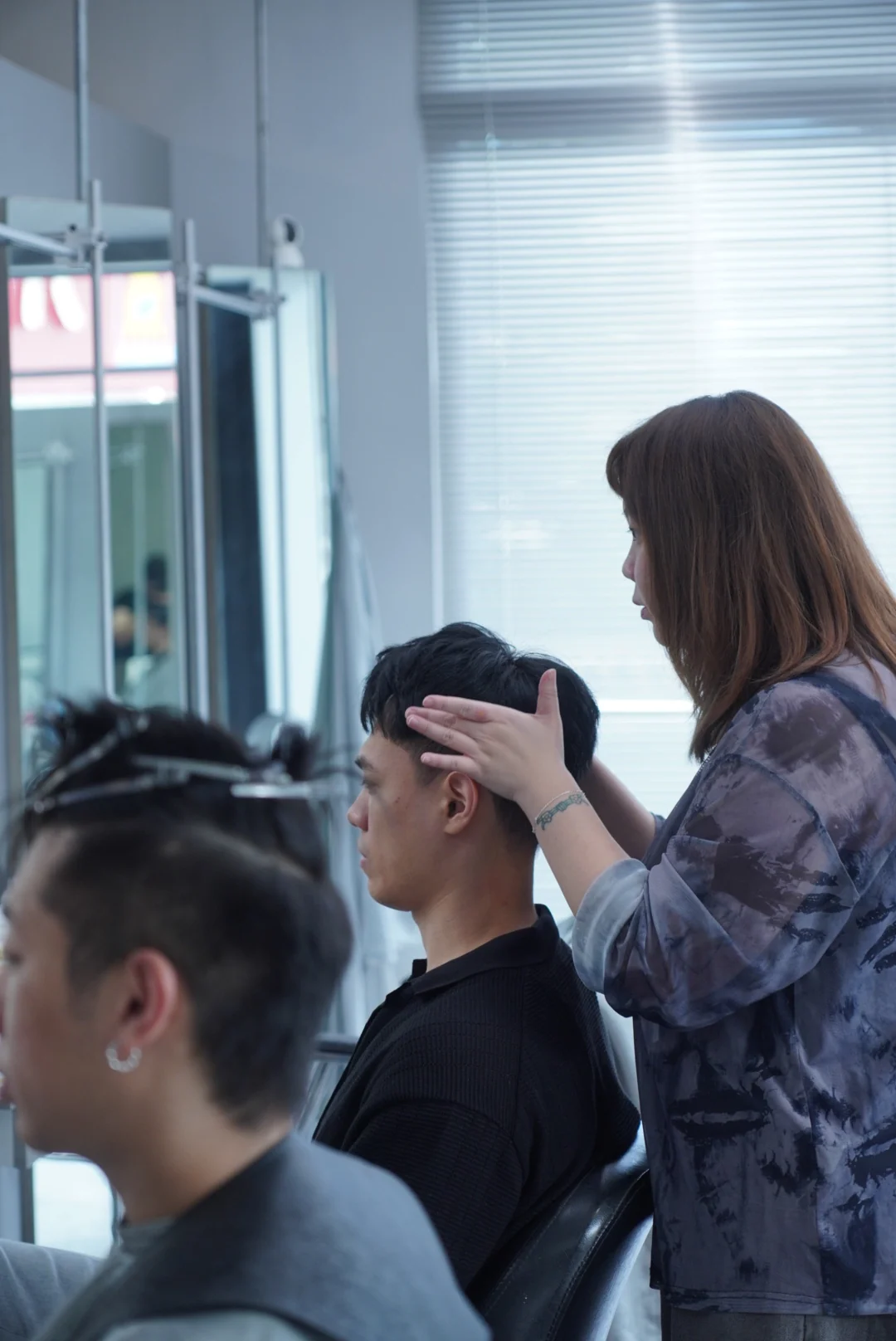 Workstations and hair being shaped in front of the mirrors
