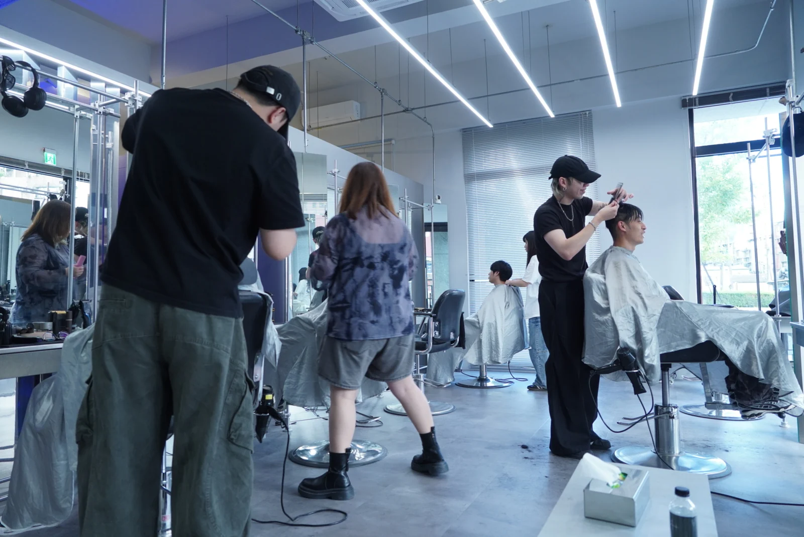Several workstations in use inside the salon