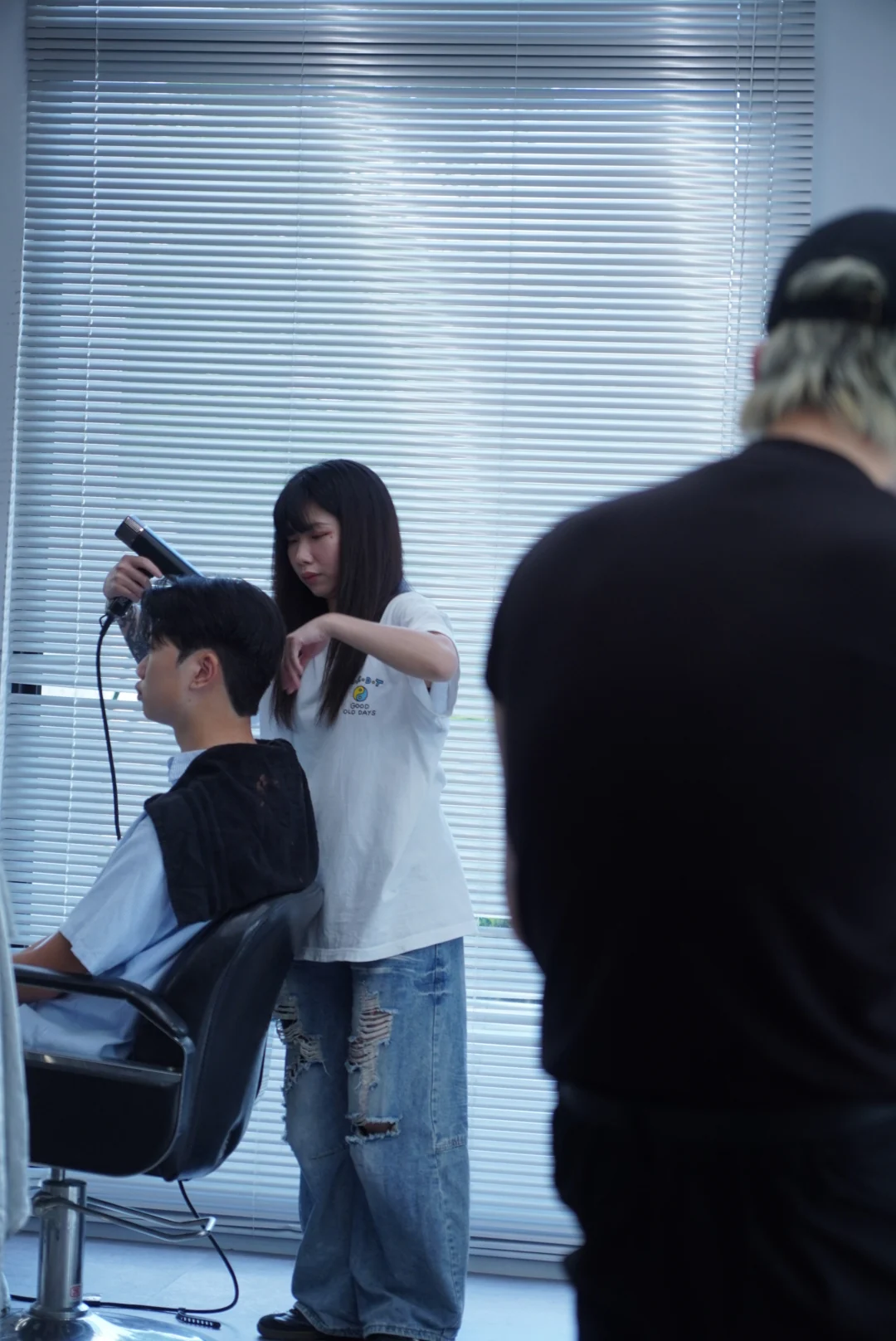 A designer and client at a chair beside the window
