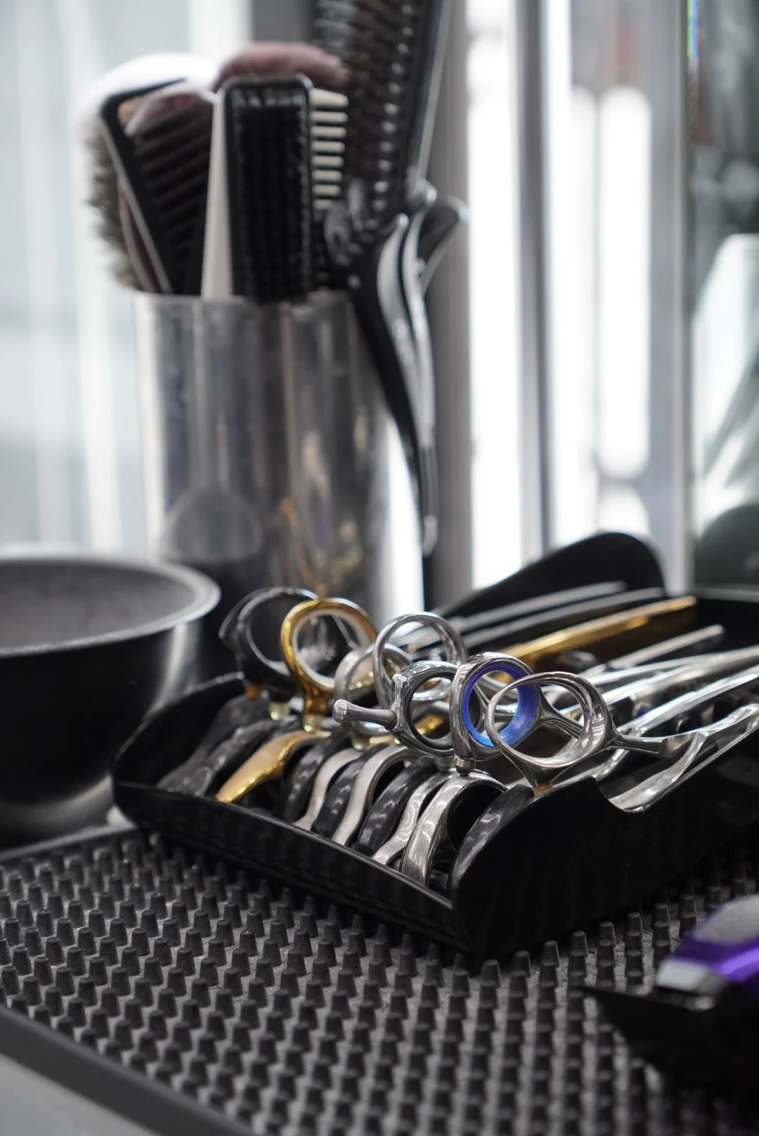 Scissors, combs and brushes on the workstation